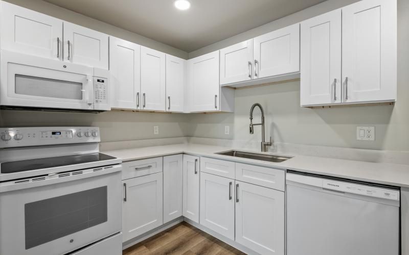 a kitchen with white cabinets
