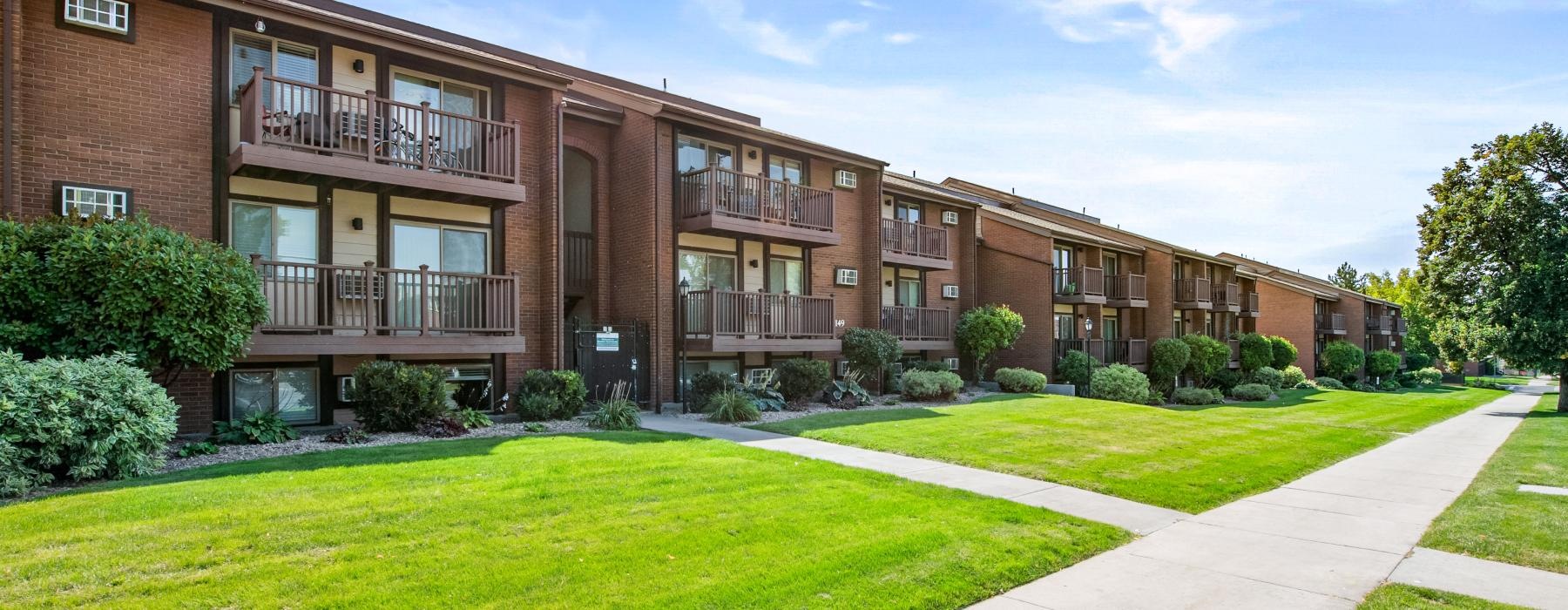 a building with a walkway and grass